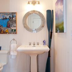 a bathroom with white walls and wood floors