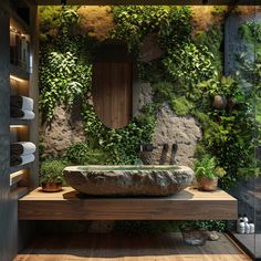 a bathroom with a stone sink and green plants on the wall behind it, surrounded by wood flooring