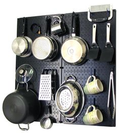 a peg board with pots and pans on it