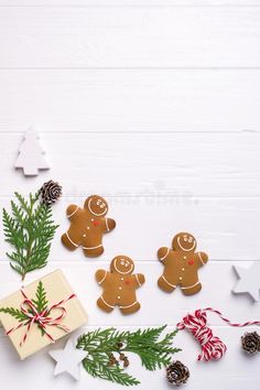 gingerbread cookies and christmas decorations on white wooden background with copy space stock images