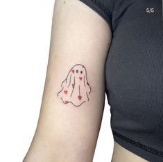 a woman's arm with a ghost tattoo on the left side of her arm