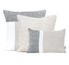 four pillows in different colors and sizes on a white background, each with a contrasting stripe