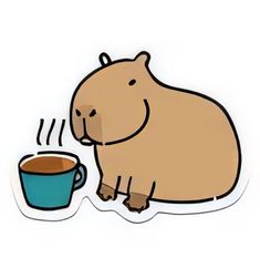 a brown hippo sitting next to a cup of coffee