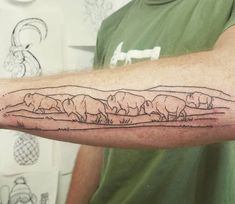 a man's arm with a line drawing of animals on it