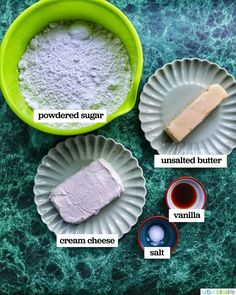 ingredients to make homemade cheesecakes displayed in paper plates on green marble counter top