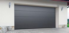 a modern garage door in front of a house