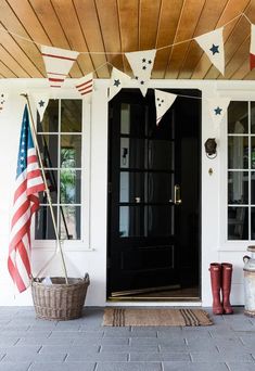 an american flag bunting on the front door of a house