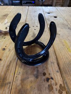 a black horseshoe sitting on top of a wooden table