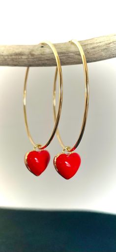 Elevate your accessory collection with these exquisite Gold filled Hoop With Red Enamel Heart Hoop Earrings, featuring a striking red heart design. Crafted with precision, these earrings combine elegance and playfulness, making them perfect for both casual and formal occasions. The vibrant red hue adds a pop of color, while the gold filled finish ensures durability and a luxurious shine. Ideal for gifting or personal indulgence, these heart-shaped hoops are a charming addition to any jewelry ensemble. Red Hoop Jewelry For Anniversary, Valentine's Day Heart Charm Dangle Hoop Earrings, Valentine's Day Dangle Hoop Earrings With Heart Charm, Heart Charm Hoop Earrings As Gift, Heart Charm Hoop Earrings For Gift, Red Double Heart Pierced Jewelry, Heart-shaped Hoop Earrings With Heart Charm Gift, Red Pierced Jewelry For Valentine's Day, Valentine's Day Heart Charm Hoop Earrings