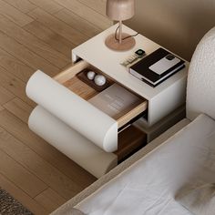 a small table with books and magazines on it next to a couch in a living room