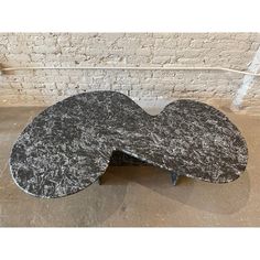 a black and white marbled coffee table in the shape of an oval shaped object