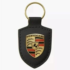 a black leather key chain with a porsche emblem on it