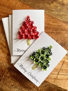 three christmas cards with red flowers on them