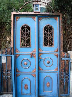 an old blue door with ornate iron work