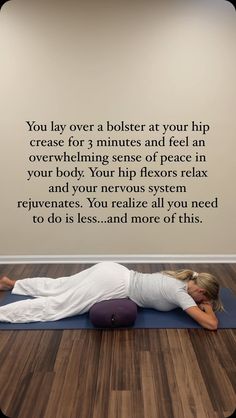 a woman is laying on her stomach in a yoga pose with the words, you lay over a bolster at your hip