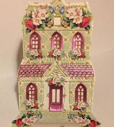 a small doll house with flowers on it