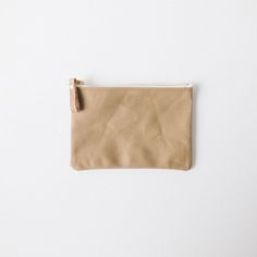 a small tan pouch sitting on top of a white table