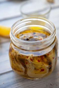 a jar filled with food sitting on top of a wooden table