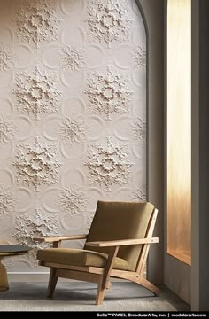 a chair and table in front of a wallpapered room with an arched window