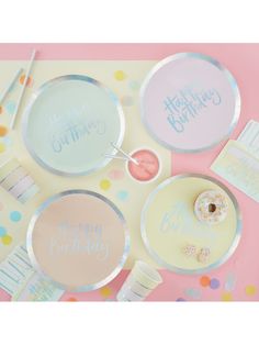 a birthday party table setting with donuts and confetti