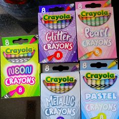 four boxes of crayons are sitting on the table