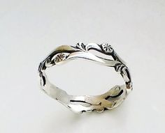 a silver ring sitting on top of a white table