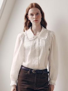 This elegant collar lace blouse is a versatile addition to your wardrobe. It features pintucks and lace on the body, with frills adorning the collar and sleeve ends. - Semi-cropped length that makes your look stylish- Made of cotton material with delicate frill details- Perfect for layering under a knit or dress, or as a standalone piece Fitted Blouse With Detachable Collar For Workwear, Feminine Blouse With Ruffled Collar For Formal Occasions, Classic Top With Lace Collar And Puff Sleeves, Classic Tops With Lace Collar And Puff Sleeves, Elegant Collared Blouse With Lace Trim, Chic Collared Blouse With Lace Trim, Cute Lace Collar Tops For Workwear, Classic Blouse With Lace Cuffs For Work, Fitted Blouse With Cute Collar For Fall