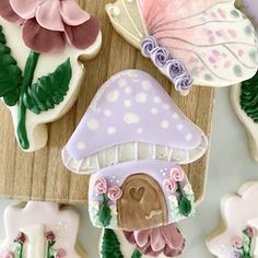 decorated cookies are arranged on a cutting board