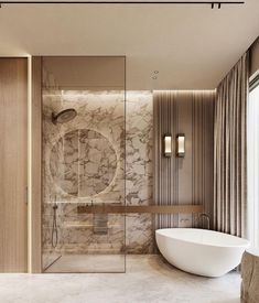 an elegant bathroom with marble walls and flooring, along with a freestanding bathtub