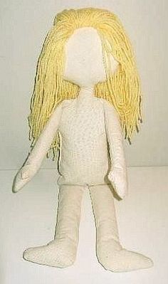 a white doll with blonde hair is posed