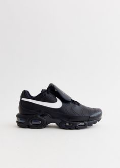 Nike has imagined and created functional, fashion-forward footwear and apparel in reflection of its sportswear roots since 1964. The Air Max Plus TNPO Sneakers seamlessly blends the iconic Air Max Plus silhouette with the timeless design of the Tiempo soccer boot, reflecting Nike's rich heritage in both fashion and athletics. Crafted from a leather upper featuring unique stitched details, this cutting-edge sneaker also boasts a Swoosh-branded fold-over tongue for a distinctive football-inspired aesthetic, ensuring superior stability and comfort. - Leather upper - Lace-up closure with fold-over tongue - Swoosh on sidewalls - 'TN' branding on the heel and outsole  - Nike Air unit for lightweight cushioning - Rubber outsole Note: International shipping is not available for this item. Material Bonfire Fits, Soccer Boots, Inspired Aesthetic, Air Max Women, Functional Fashion, Nike Air Max Plus, Air Max Plus, Black Sneakers, Sneakers Athletic