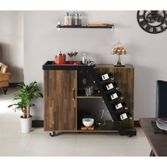 a wooden cabinet with wine bottles and glasses on it in front of a wall clock