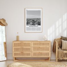 a living room with white walls and wooden furniture in front of a large poster on the wall