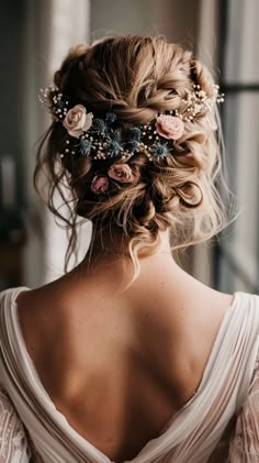 the back of a woman's head with flowers and pearls in her wedding hair