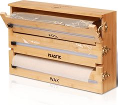 a wooden box with three compartments containing different types of wax and plastic wrap on it