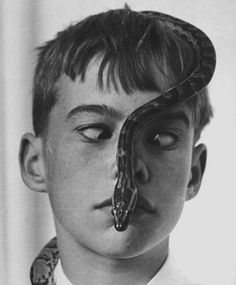 a boy with a snake on his nose