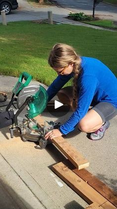 a woman working on some wood with a circular saw