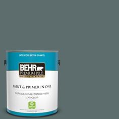 a can of behr premium plus paint and primer in one on a blue background