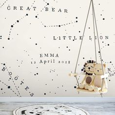 a child's room with a wallpaper and a teddy bear on a swing