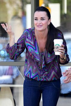 a woman holding a coffee cup and smiling