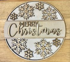 a wooden sign that says merry christmas with snowflakes