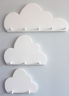 two white clouds are hanging on the wall