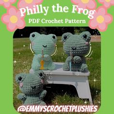 three crocheted stuffed animals sitting on top of a white bench in the grass