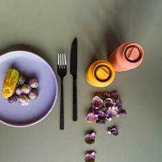 a purple plate with flowers and two forks next to it