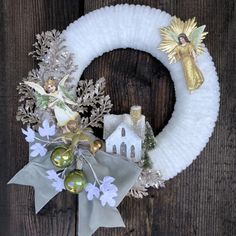 a christmas wreath with angel decorations on it