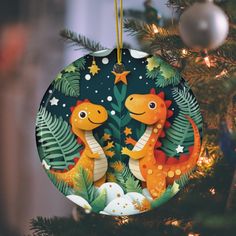 a christmas ornament with two dinosaurs on it