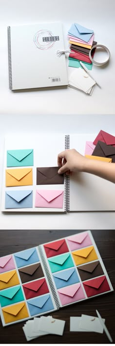 an open notebook with several different colored envelopes on the cover and in front of it