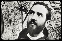 black and white photograph of a man with a beard looking up at something in the distance