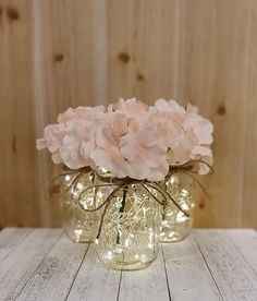 three mason jars with pink flowers in them