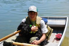 a person in a boat with a dog